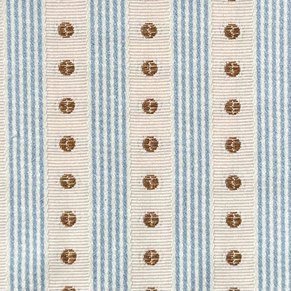 Close-up of a fabric with blue and beige stripes and brown circular patterns.