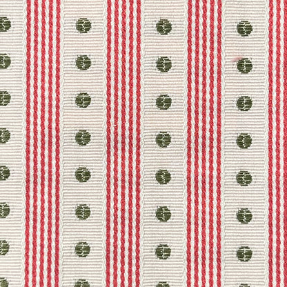 Close-up of a ribbon with red and white stripes and green floral patterns.