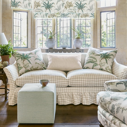 Living room with a checkered sofa, ottoman, and decorative pillows.