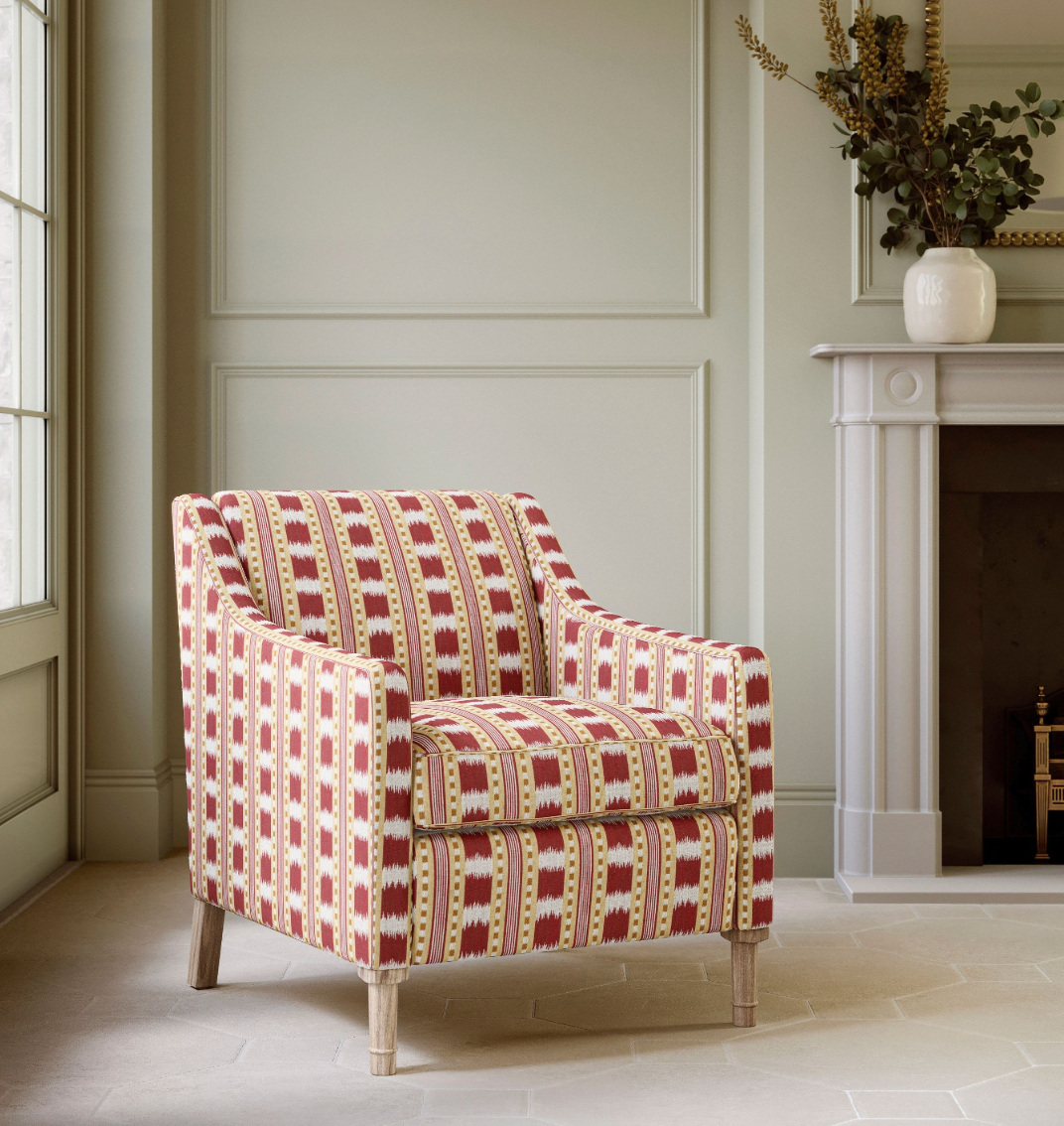 Ikat Striper Paxton James Hare Red Gold Chair illustrating how the fabric looks on furniture
