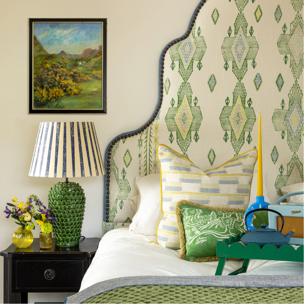 Room designed by interior designer Jo Bee. Escape into this bedroom - a serene retreat where Travelling Light in Green takes centre stage. Upholstered as a bold, sculptural headboard, the fabric becomes the heart of the room, setting the tone for a space that feels quietly luxurious and deeply restful.