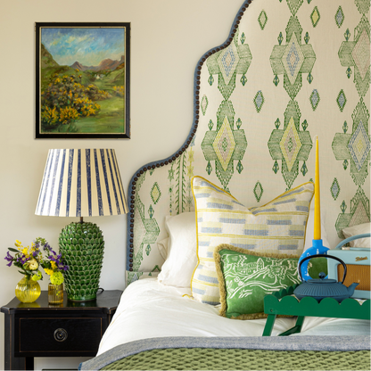 Room designed by interior designer Jo Bee. Escape into this bedroom - a serene retreat where Travelling Light in Green takes centre stage. Upholstered as a bold, sculptural headboard, the fabric becomes the heart of the room, setting the tone for a space that feels quietly luxurious and deeply restful.